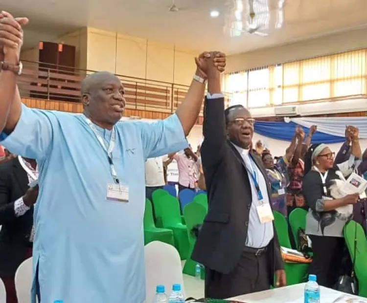 CCSL members and Rev. Fidon Mwombeki holding hands during the celebrations 